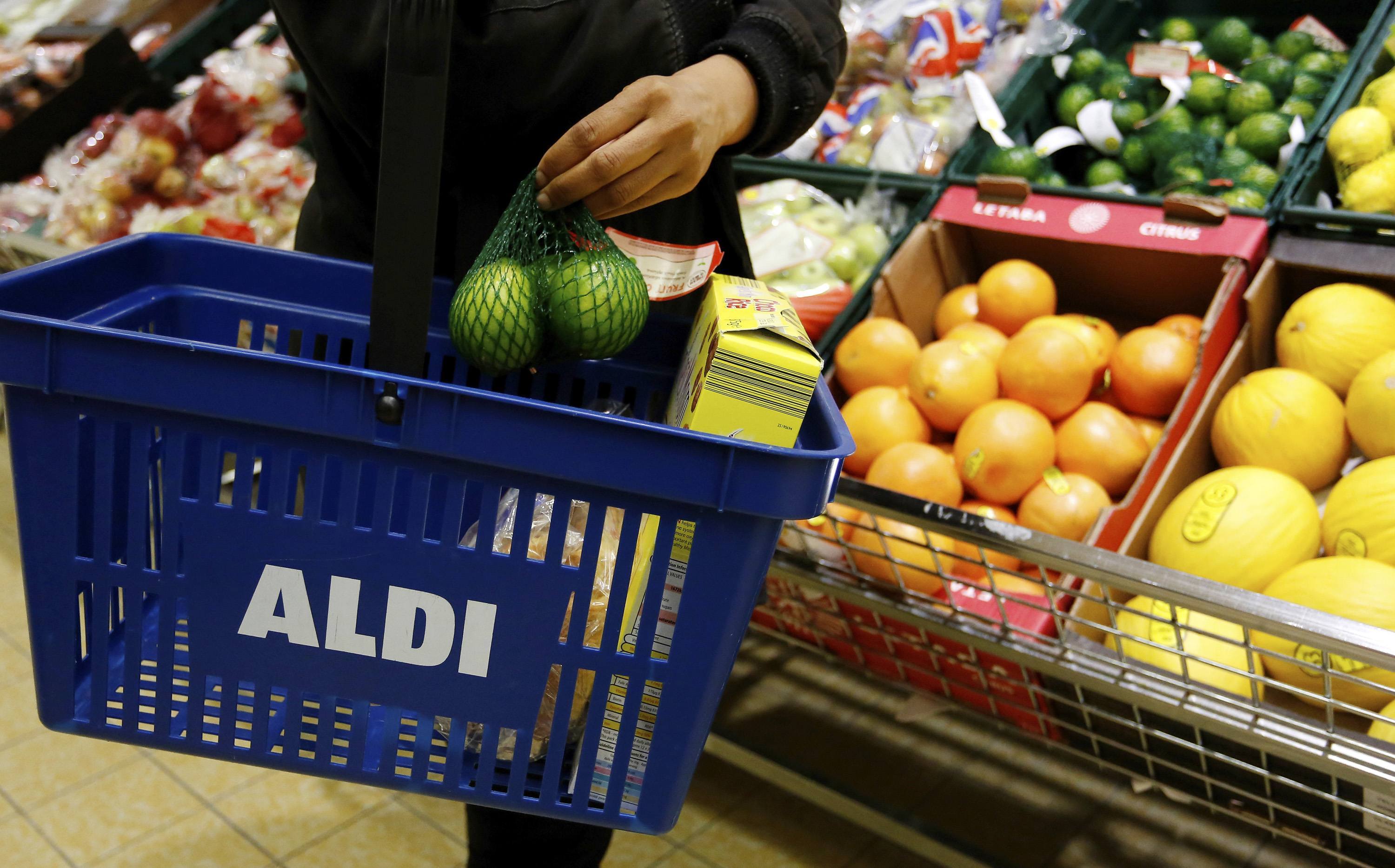 A customer places a bag of limes into her basket at a supermarket operated by Aldi Group, Germany's biggest discount-food retailer, in Manchester, U.K., on Thursday, Oct. 4, 2012. U.K. shop-price inflation slowed in September as retailers offered discounts to attract cash-strapped consumers, the British Retail Consortium said. Photographer: Paul Thomas/Bloomberg
